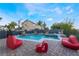 Sparkling pool area with a serene water feature, playful art, and inviting lounge chairs at 1168 Spago Ln, Henderson, NV 89052
