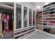 Custom walk-in closet with ample hanging space, shelving, and shoe storage at 1168 Spago Ln, Henderson, NV 89052