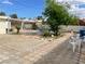 Large backyard with mature tree, brick and stone landscaping, and lounge chairs at 1320 Norman Ave, Las Vegas, NV 89104