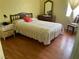 Cozy bedroom with wood floors, large window, and natural colored walls at 1320 Norman Ave, Las Vegas, NV 89104
