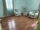 Comfortable room with hardwood flooring, floral chairs and an abundance of light at 1320 Norman Ave, Las Vegas, NV 89104