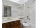 Bright bathroom with tiled walls, a large mirror, and a combined tub and shower at 1701 E Katie Ave # 36, Las Vegas, NV 89119