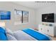 Virtually staged bedroom with a ocean themed painting and TV at 1701 E Katie Ave # 36, Las Vegas, NV 89119