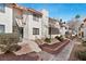 Charming condo featuring stucco walls, a red tile roof, and mature landscaping, offering a warm, inviting curb appeal at 1701 E Katie Ave # 36, Las Vegas, NV 89119
