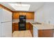 Functional kitchen featuring laminate countertops, white appliances, and light wood cabinets, creating an efficient cooking space at 1701 E Katie Ave # 36, Las Vegas, NV 89119