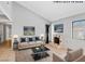 Bright living room featuring a fireplace, neutral decor, and large window, creating a cozy and inviting atmosphere at 1701 E Katie Ave # 36, Las Vegas, NV 89119
