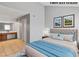 Virtually staged main bedroom with neutral walls, tiled floor and a glimpse of an ensuite bathroom at 1701 E Katie Ave # 36, Las Vegas, NV 89119