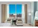 Bright main bedroom with sitting area and city views, featuring plush seating and floor-to-ceiling windows at 2000 Fashion Show Dr # 6109, Las Vegas, NV 89109