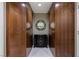 Modern walk-in closet with wood cabinets, dresser, and circular mirror at 2000 Fashion Show Dr # 6109, Las Vegas, NV 89109