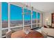Bright dining area with city view, featuring a round wood table and modern chandelier fixture at 2000 Fashion Show Dr # 6109, Las Vegas, NV 89109