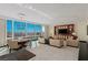 Open-concept living room with dining area, built-in media center, and panoramic city views at 2000 Fashion Show Dr # 6109, Las Vegas, NV 89109