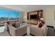 Elegant living room with sleek furniture, city views and custom entertainment center with TV at 2000 Fashion Show Dr # 6109, Las Vegas, NV 89109