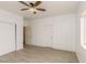 Bright bedroom features wood-look floors, white walls, ceiling fan, closet and natural light from the window at 2128 La Salle St, Las Vegas, NV 89106