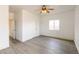 Bedroom with wood-look floors, ceiling fan, two closets, and a large window at 2128 La Salle St, Las Vegas, NV 89106