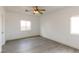 Bedroom with wood-look floors, ceiling fan, and a large window for natural light at 2128 La Salle St, Las Vegas, NV 89106