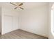 A simple bedroom features a closet, wood-look flooring and a ceiling fan at 2128 La Salle St, Las Vegas, NV 89106