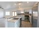 Spacious kitchen with stainless steel appliances, breakfast bar, mosaic backsplash, and lots of natural light at 2128 La Salle St, Las Vegas, NV 89106