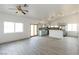 Open-concept living room and kitchen with stainless steel appliances, light blue cabinets, and wood-look floors at 2128 La Salle St, Las Vegas, NV 89106