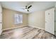 Bedroom features wood-look floors, a ceiling fan, and a window for natural light at 2200 S Fort Apache Rd # 2153, Las Vegas, NV 89117