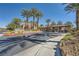 A grand entrance showcases mature palm trees, stone accents, and a gated entry at 2200 S Fort Apache Rd # 2153, Las Vegas, NV 89117