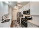 Contemporary kitchen with white cabinets, stainless steel appliances, and stylish lighting fixtures at 2200 S Fort Apache Rd # 2153, Las Vegas, NV 89117