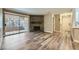 Bright living room features wood-look flooring and a stone fireplace with sliding door to patio at 2200 S Fort Apache Rd # 2153, Las Vegas, NV 89117