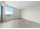 Bright bedroom featuring neutral walls, tile flooring, and a large picture window at 222 Karen Ave # 1908, Las Vegas, NV 89109