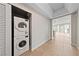 Hallway features tile floor, laundry closet with stacked washer/dryer, and views to city at 222 Karen Ave # 1908, Las Vegas, NV 89109