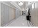 Hallway with marble floors and neutral colors. Elevator, mirror and console table at 222 Karen Ave # 1908, Las Vegas, NV 89109