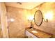 Bathroom featuring a granite countertop, travertine tile and vanity mirror at 30 Strada Di Villaggio # 118, Henderson, NV 89011