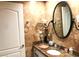Bathroom featuring a granite countertop, travertine tile and vanity mirror at 30 Strada Di Villaggio # 118, Henderson, NV 89011
