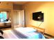 Bedroom featuring an entertainment center, and mirrored closet doors at 30 Strada Di Villaggio # 118, Henderson, NV 89011