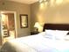 This main bedroom has a large bed, with an ensuite bathroom featuring a soaking tub at 30 Strada Di Villaggio # 118, Henderson, NV 89011