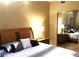 Comfortable bedroom featuring a mirrored closet and warm lighting at 30 Strada Di Villaggio # 118, Henderson, NV 89011