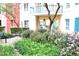 Courtyard area with flowering plants, small trees and decorative shrubs, with a balcony visible from a condo unit at 30 Strada Di Villaggio # 118, Henderson, NV 89011