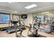 This gym features modern treadmill and bike equipment, windows, and a mounted TV at 30 Strada Di Villaggio # 118, Henderson, NV 89011