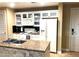 Practical kitchen featuring white appliances, cabinets and ample countertop space at 30 Strada Di Villaggio # 118, Henderson, NV 89011