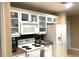 Well-lit kitchen with white appliances, cabinets, breakfast bar and countertop appliances at 30 Strada Di Villaggio # 118, Henderson, NV 89011