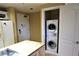 Kitchen with door leading to stacked washer and dryer unit at 30 Strada Di Villaggio # 118, Henderson, NV 89011