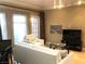 Comfortable living room with sofa, chair and large TV with access to a balcony at 30 Strada Di Villaggio # 118, Henderson, NV 89011