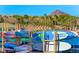 Paddleboards neatly stacked by the water, perfect for enjoying lake activities with mountain view in the background at 30 Strada Di Villaggio # 118, Henderson, NV 89011