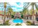 Resort style pool with surrounding palms, covered seating areas and luxurious condos at 30 Strada Di Villaggio # 118, Henderson, NV 89011