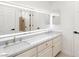 Bright bathroom with double sink vanity, large mirror, and white cabinets with gold hardware at 3021 Ocean Port Dr, Las Vegas, NV 89117