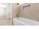 Bright bathroom with large tub, shower head, window, and tiled walls at 3021 Ocean Port Dr, Las Vegas, NV 89117