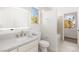 Bright bathroom featuring a vanity, toilet, and shower with a window at 3021 Ocean Port Dr, Las Vegas, NV 89117