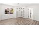 Bedroom with window, built-in shelving, laminate flooring, and white painted trim at 3021 Ocean Port Dr, Las Vegas, NV 89117