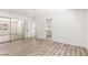 Bright bedroom with modern floors, mirrored closet doors, and entrance to the bathroom at 3021 Ocean Port Dr, Las Vegas, NV 89117
