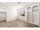 Bedroom with window, built-in shelving, closet, laminate flooring, and white painted trim at 3021 Ocean Port Dr, Las Vegas, NV 89117
