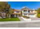 Charming two-story home featuring a red tile roof, manicured lawn, and inviting curb appeal at 3021 Ocean Port Dr, Las Vegas, NV 89117