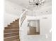 Bright foyer showcases a staircase with white railings and wood steps, leading to an upper level at 3021 Ocean Port Dr, Las Vegas, NV 89117